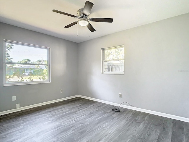 unfurnished room with ceiling fan and dark hardwood / wood-style flooring