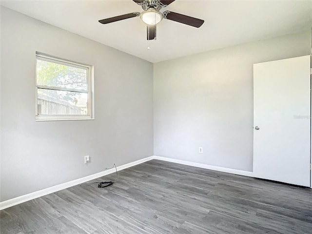 empty room featuring ceiling fan and dark wood-type flooring