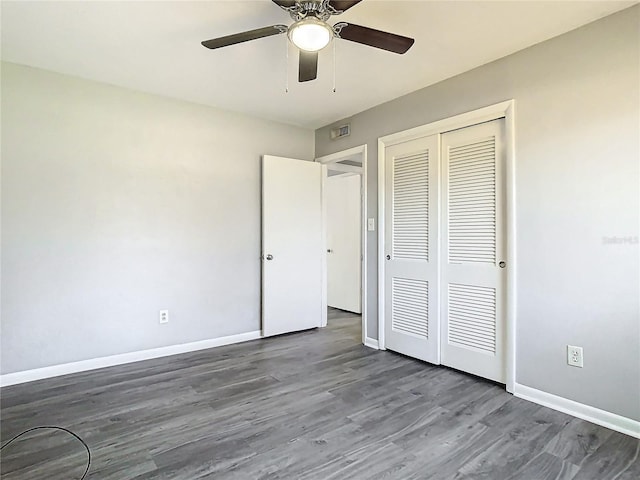 unfurnished bedroom with ceiling fan, a closet, and hardwood / wood-style flooring