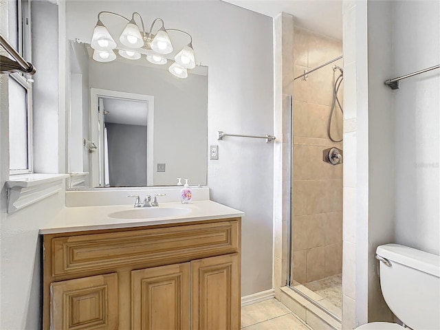 bathroom with tile patterned floors, vanity, toilet, and a shower with shower door