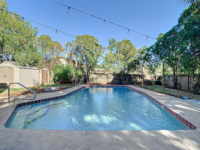 view of pool featuring a patio and a shed