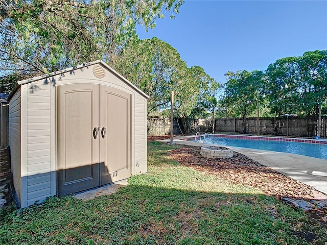 view of outbuilding featuring a fenced in pool and a lawn