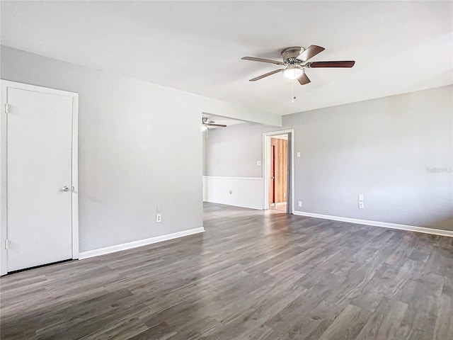 unfurnished room with ceiling fan and dark hardwood / wood-style flooring