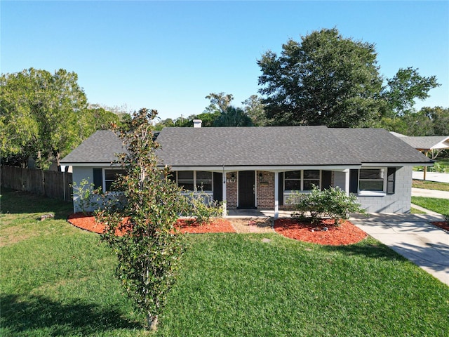 ranch-style house with a front lawn, roof with shingles, a porch, and fence