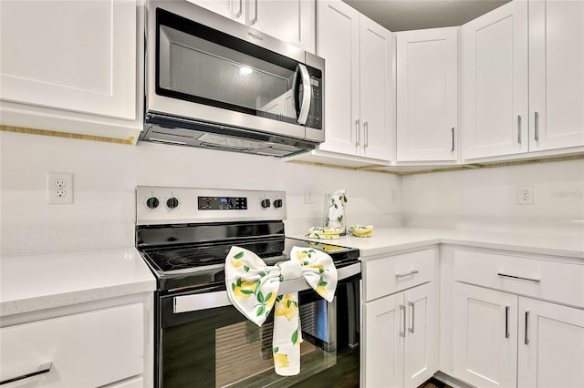 kitchen with white cabinetry and appliances with stainless steel finishes