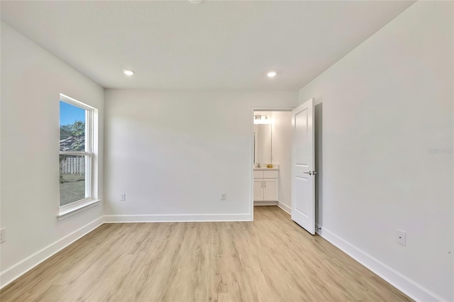 spare room with light wood-type flooring