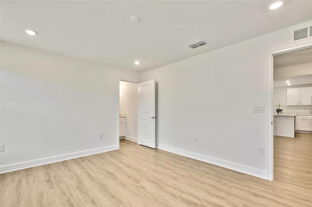 unfurnished room with light hardwood / wood-style flooring