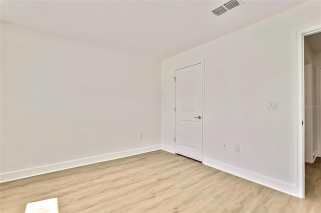 unfurnished room with light wood-type flooring