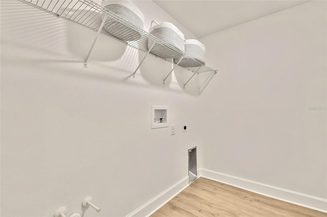 clothes washing area featuring hookup for an electric dryer, washer hookup, hardwood / wood-style flooring, and hookup for a gas dryer