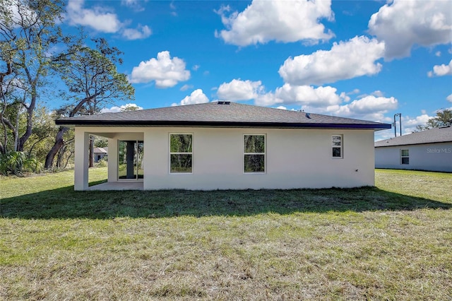 back of property featuring a patio area and a yard