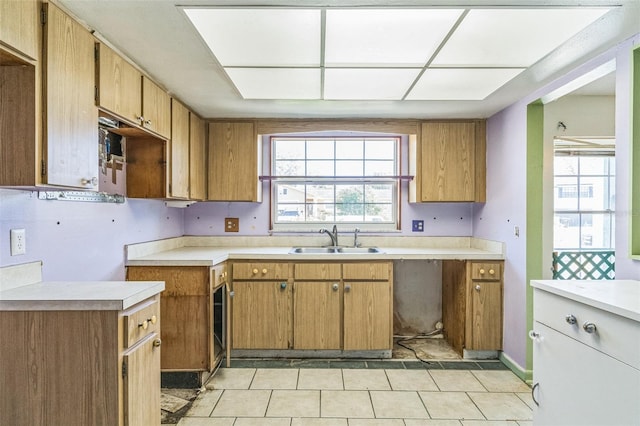 kitchen featuring light tile patterned floors and sink