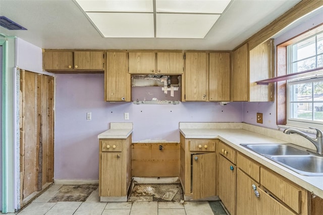 kitchen with light tile patterned flooring, a wealth of natural light, and sink