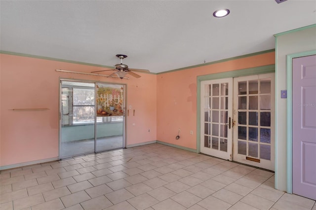 tiled empty room featuring ceiling fan, french doors, and crown molding