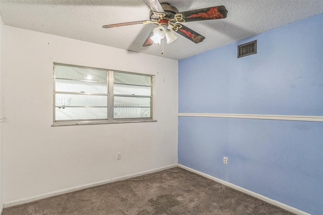 carpeted spare room with ceiling fan and a textured ceiling