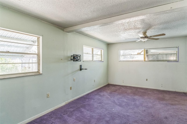 unfurnished room featuring beamed ceiling, ceiling fan, carpet floors, and a textured ceiling