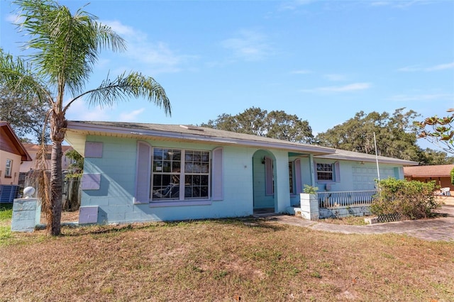 ranch-style house with a front yard and a porch