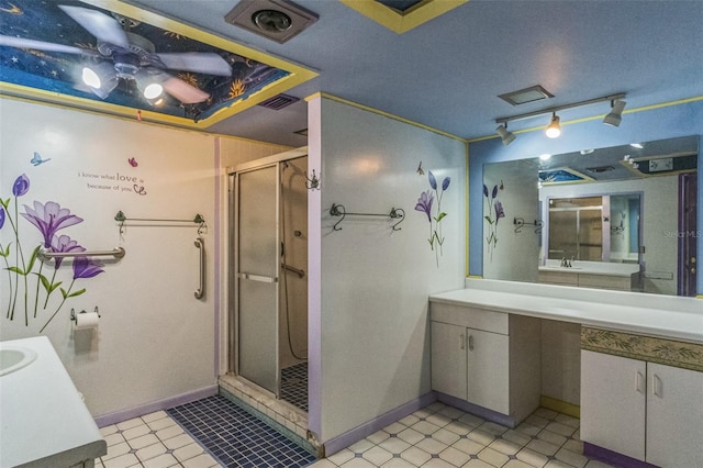 bathroom featuring tile patterned floors, vanity, ceiling fan, and a shower with door