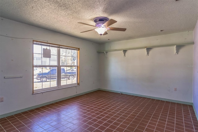 empty room featuring a textured ceiling and ceiling fan