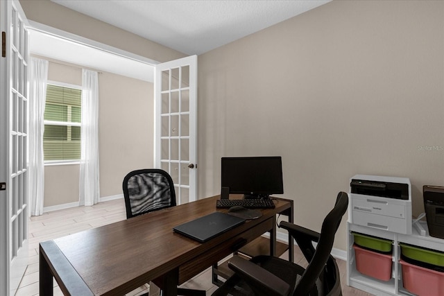 office area with french doors and light hardwood / wood-style floors