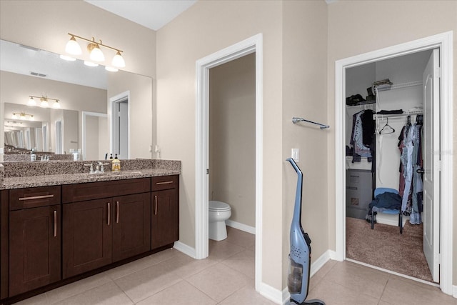 bathroom featuring tile patterned floors, vanity, and toilet