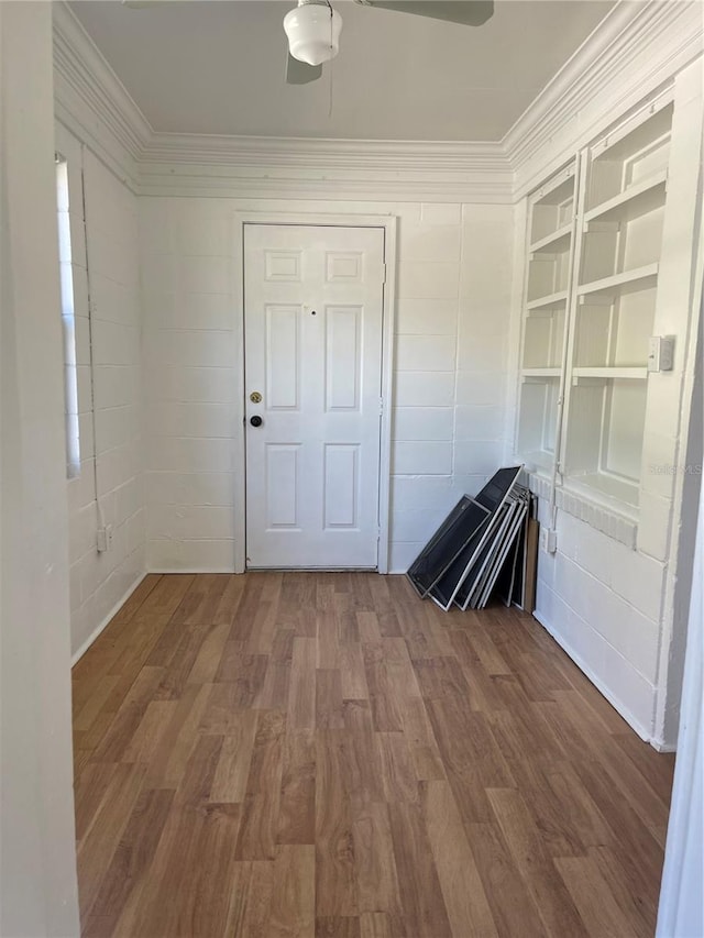 interior space with hardwood / wood-style flooring and ornamental molding