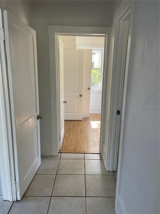 hallway with light hardwood / wood-style flooring