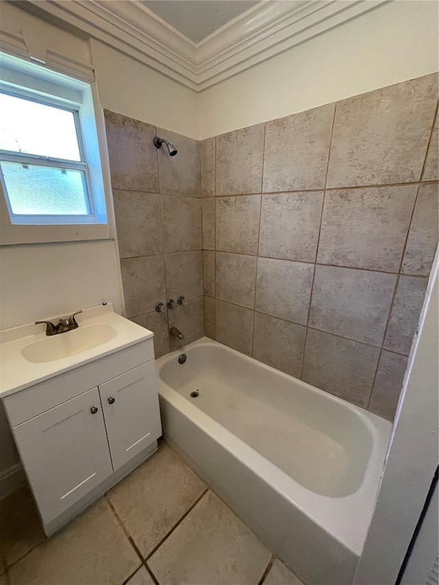 bathroom featuring tile patterned flooring, vanity, tiled shower / bath combo, and ornamental molding