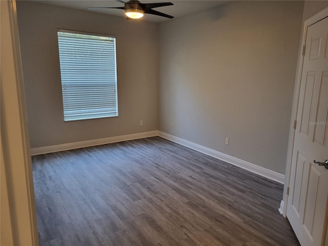 spare room featuring ceiling fan and dark wood-type flooring