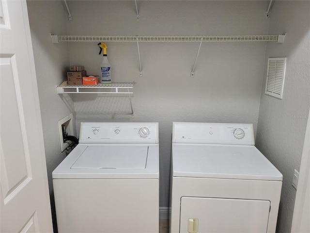 clothes washing area featuring separate washer and dryer