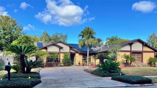 view of front facade featuring solar panels