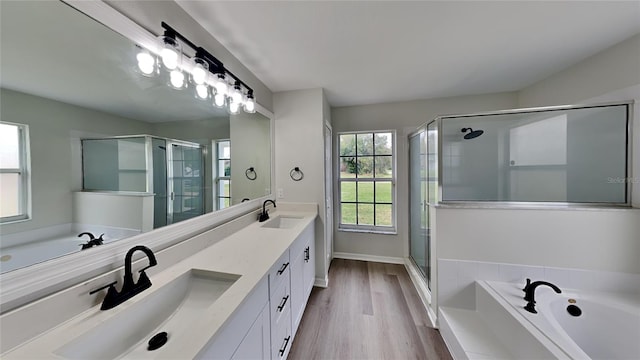 bathroom with hardwood / wood-style floors, vanity, and independent shower and bath