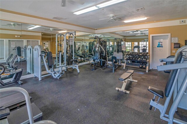 gym featuring ceiling fan and a textured ceiling