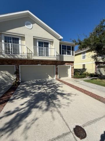 view of front facade with a balcony and a garage