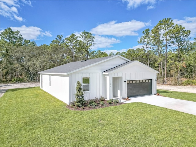 view of front of property featuring a garage and a front lawn