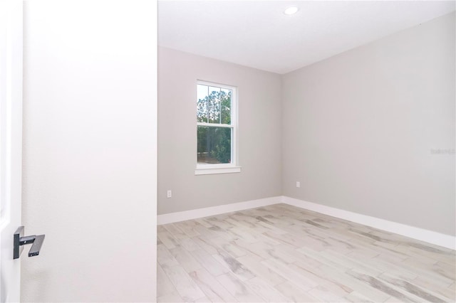 spare room featuring light hardwood / wood-style floors