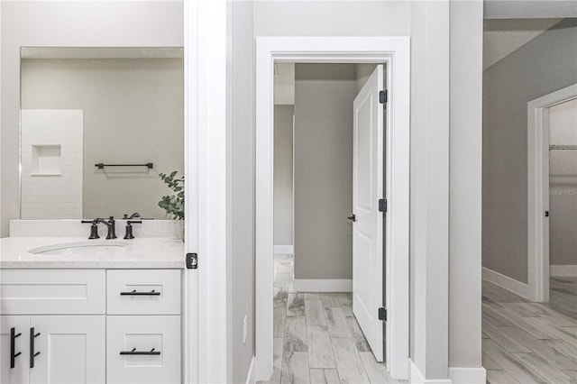 bathroom with a shower, vanity, and hardwood / wood-style flooring