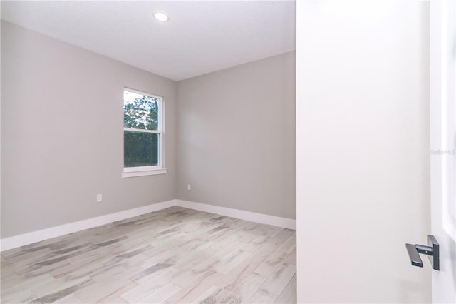 empty room with light hardwood / wood-style flooring