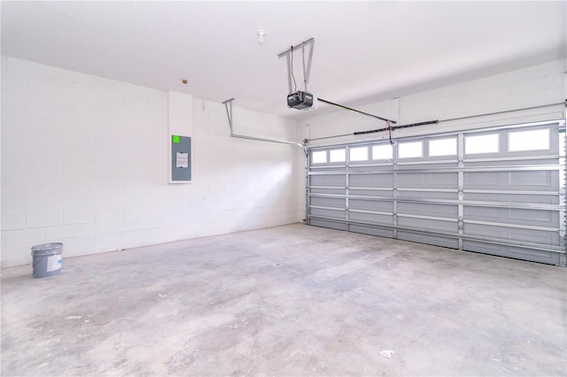 garage with electric panel and a garage door opener