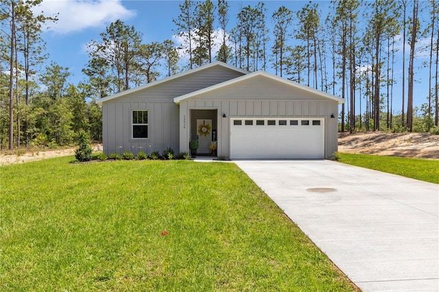 13516 SW 78th Pl, Dunnellon, FL 34432 - view of front of property with board and batten siding, a garage, a front lawn, and concrete driveway