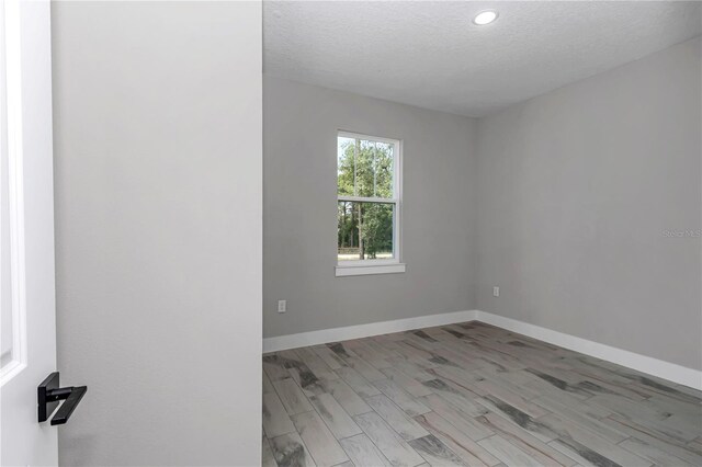 13516 SW 78th Pl, Dunnellon, FL 34432 - empty room featuring a textured ceiling, baseboards, light wood finished floors, and recessed lighting
