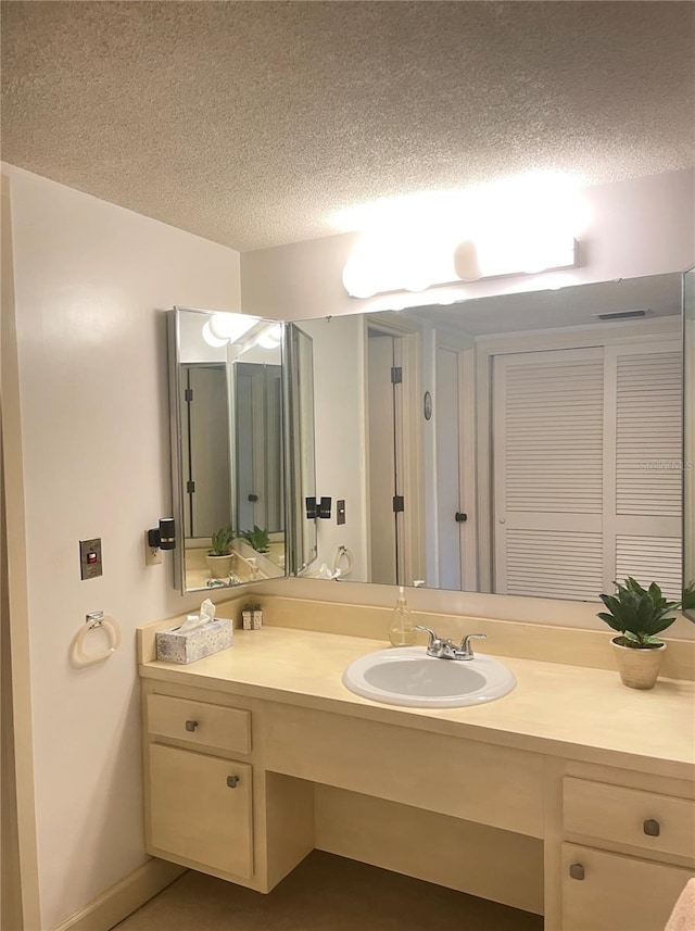 bathroom with vanity and a textured ceiling