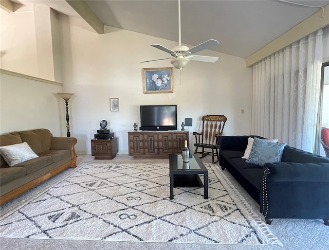 living room featuring lofted ceiling with beams, ceiling fan, and light carpet