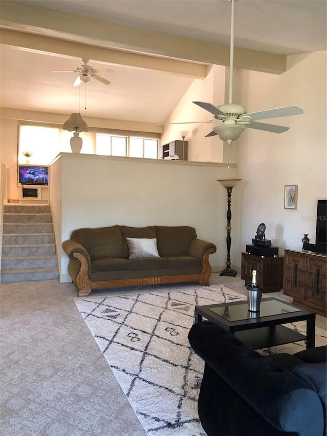 carpeted living room with vaulted ceiling with beams