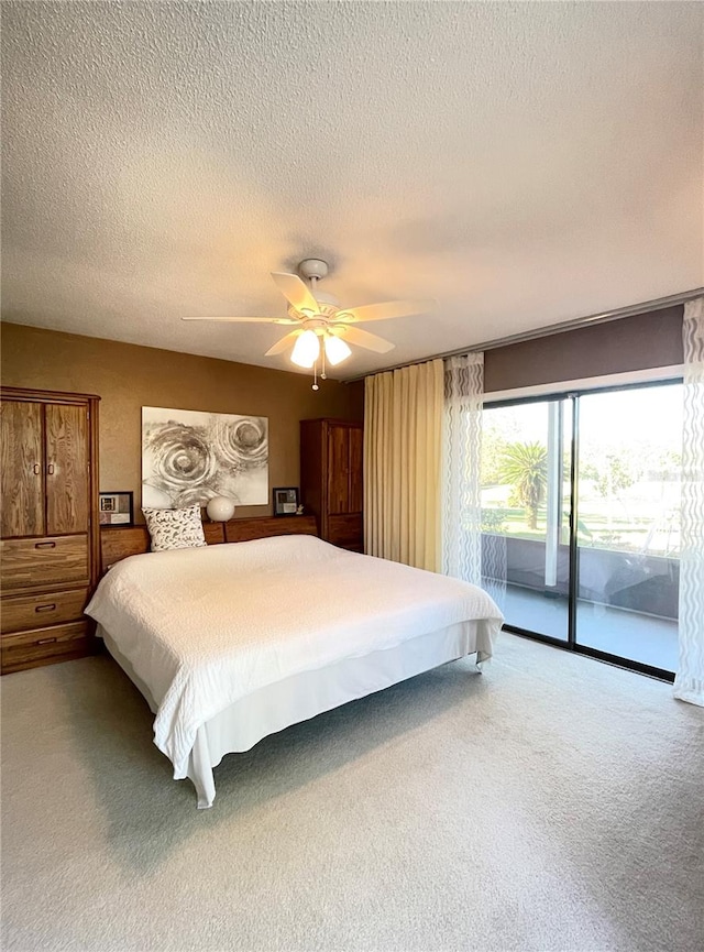 bedroom with carpet flooring, access to exterior, ceiling fan, and a textured ceiling