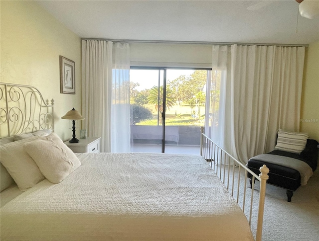 bedroom featuring access to outside, ceiling fan, and carpet flooring