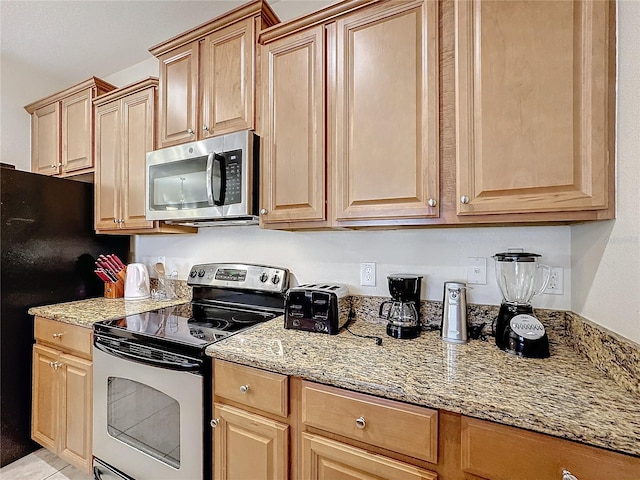 kitchen featuring light stone countertops and appliances with stainless steel finishes