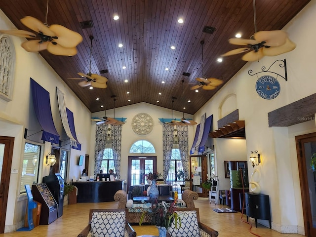 tiled living room with wooden ceiling, high vaulted ceiling, and french doors