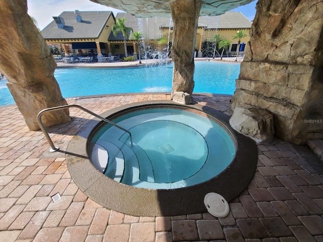 view of swimming pool featuring a community hot tub