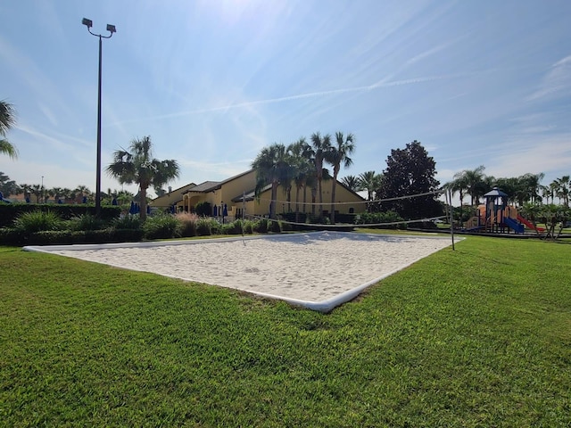 view of property's community with a playground and a yard