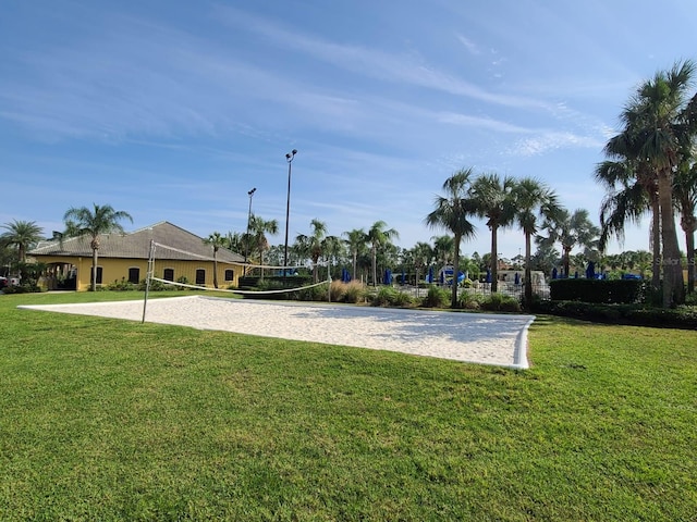 view of property's community featuring volleyball court and a lawn